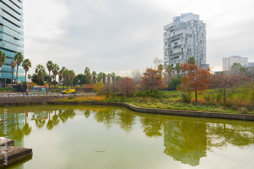 buildings and park with lake in downtown city in autumn