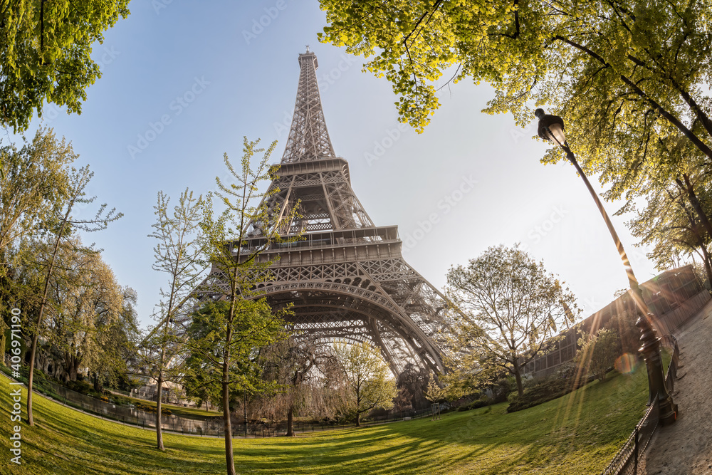 Eiffel Tower with spring trees against sunrise in Paris, France