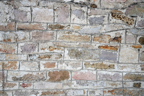 texture of an old stone wall with masonry seams