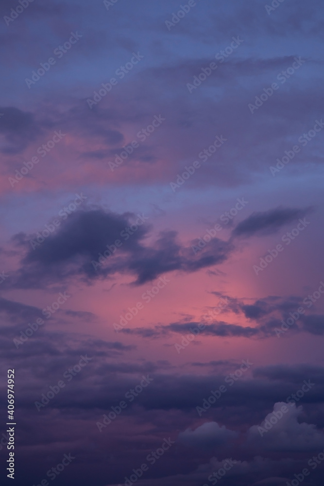 Sunrise, sunset pink violet blue sky with dark storm clouds background texture