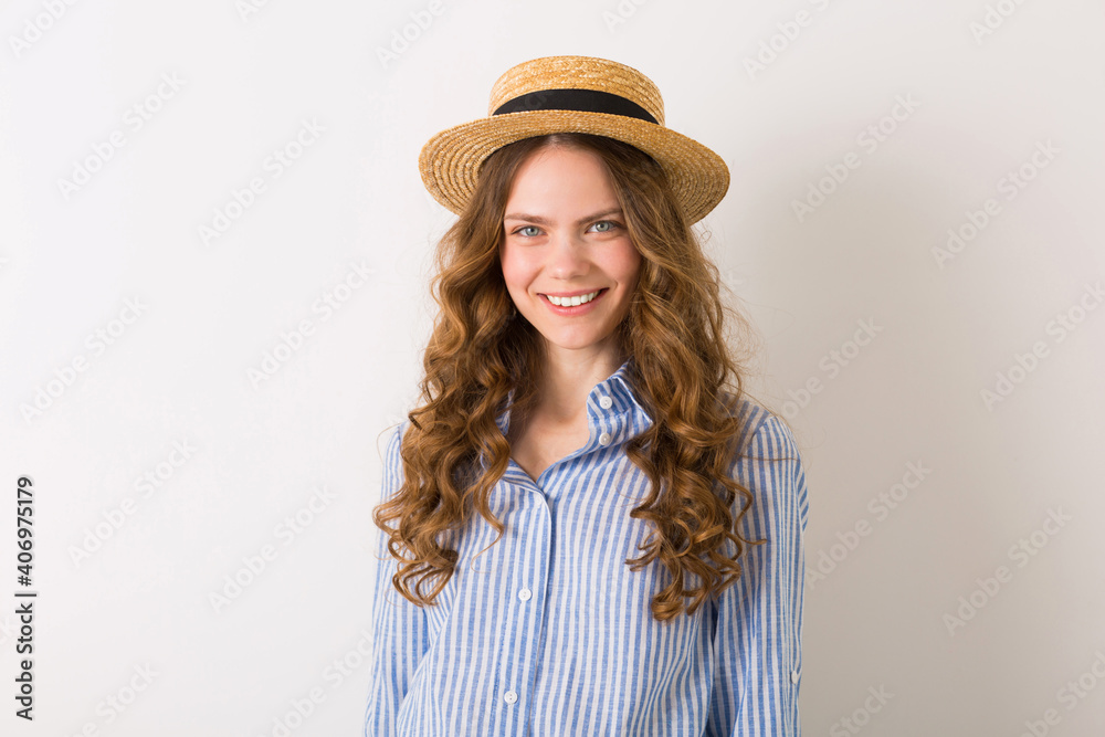 young beautiful stylish woman in summer style outfit posing on white wall wearing straw hat young beautiful stylish woman in summer style outfit posing on white wall wearing straw hat