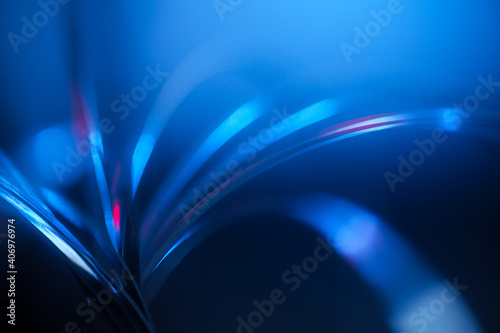 futuristic blurry abstract background in blue and red cinematic tones. strings, strips of arcs and with light highlights.
