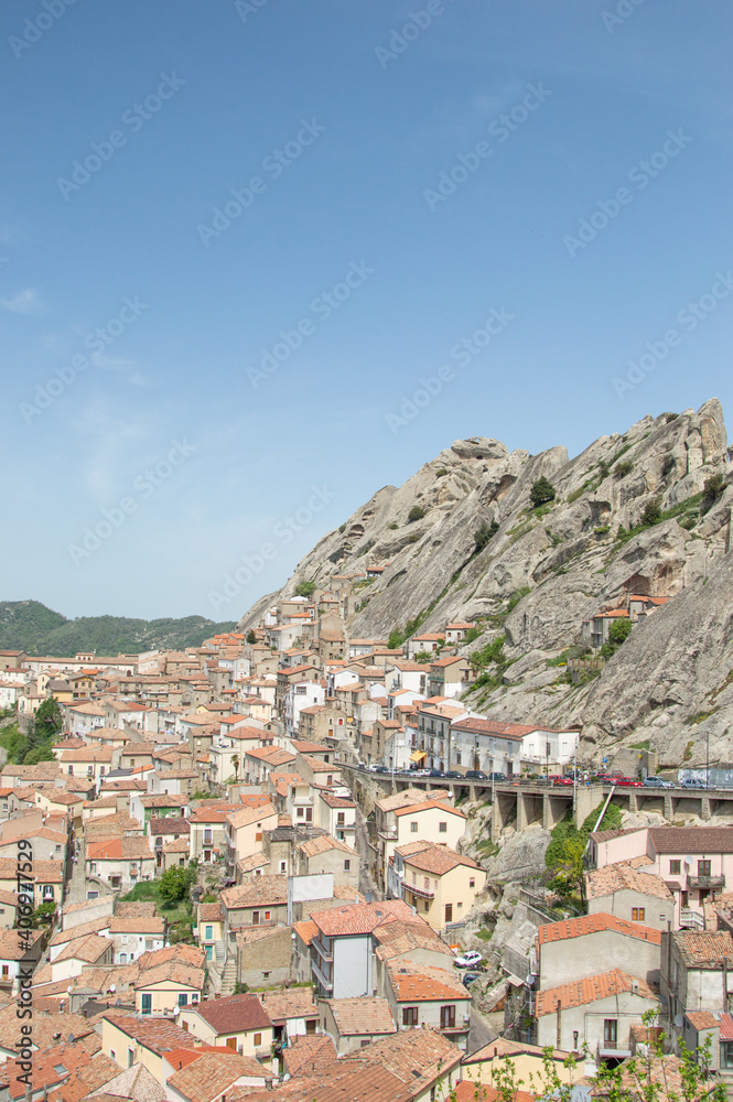 view of the small village of Pietrapertosa in Basilicata, Italy with background of mountains and forest