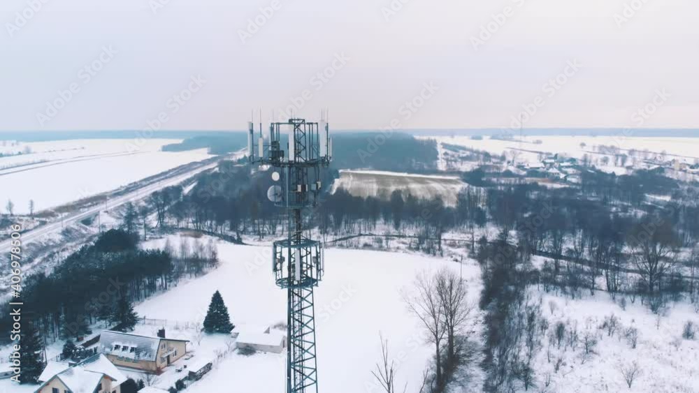 Snow falling at 5g antenna Aerial orbiting shot. Telecommunication tower. High quality 4k footage