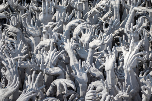 many gray hand statues that suffering in concept of the Buddhism hell photo