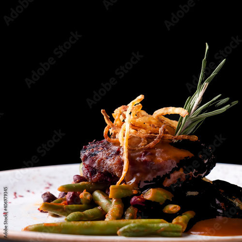 Chopped meat steak with harricot and onion chips photo