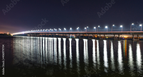 Fototapeta Naklejka Na Ścianę i Meble -  Reflection of bright lanterns in the Dnieper river under the bridge
