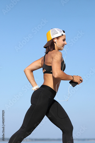 young woman jogging by the sea photo