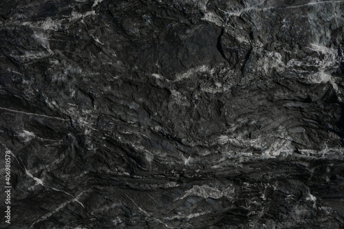 Black rough stone wall texture for background or wallpaper.