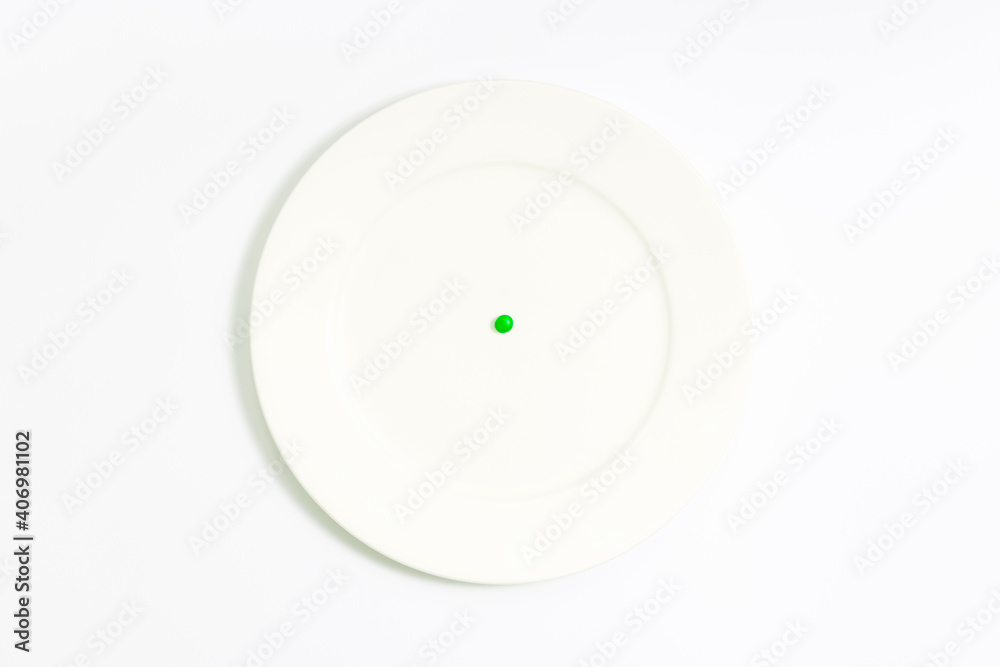 diet, one single green pea on white empty plate, white background, top view, close up diet, one single green pea on white empty plate, white background, top view, close up