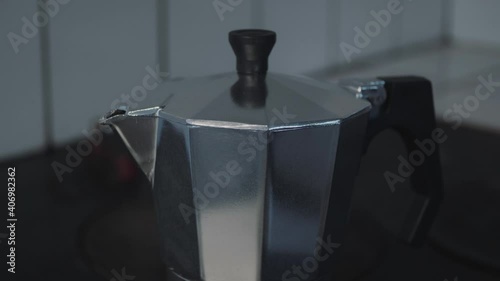 Close up of An Italian moka pot brews coffee on a wood stove