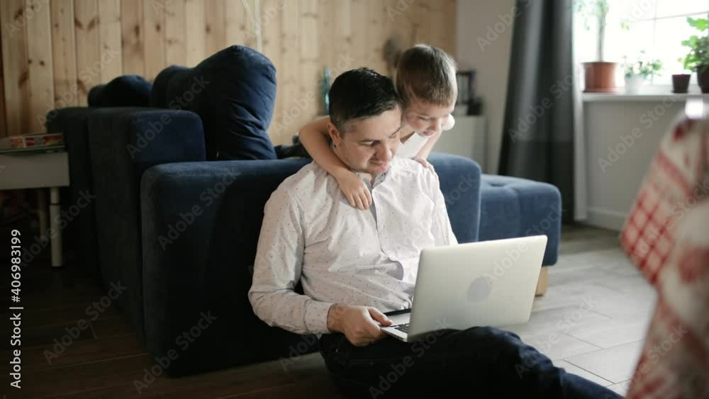 Remote lessons for kids. Dad and son are doing homework together on laptop, distance education and parenthood concept, lockdown and quarantine during covid-19 pandemic. Father is teaching his boy. Remote lessons for kids. Dad and son are doing homework together on laptop, distance education and parenthood concept, lockdown and quarantine during covid-19 pandemic. Father is teaching his boy.