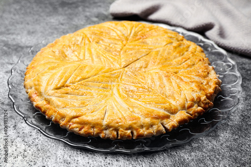 Traditional galette des rois on grey table, closeup