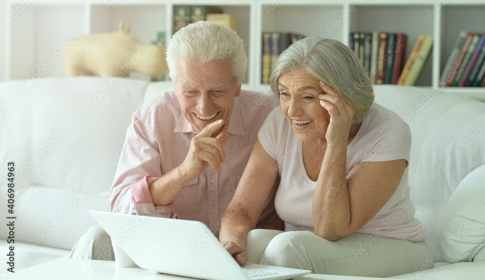 happy senior couple with laptop at home happy senior couple with laptop at home