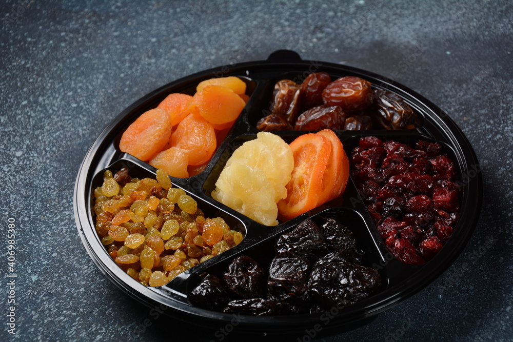 Mix of dried and sun-dried fruits,  in a wooden trays . View from above. Symbols of the Jewish holiday of Tu BiShvat
