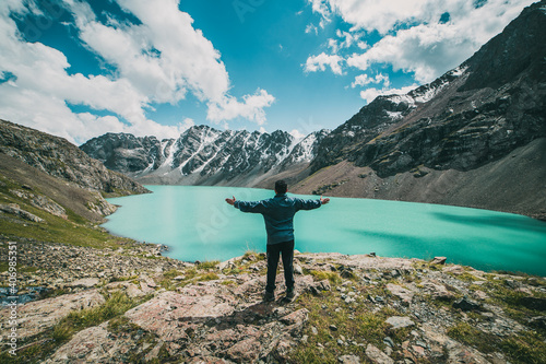 Fototapeta Naklejka Na Ścianę i Meble -  A guy celebrating arrival at Ala Kul lake at 3600 meters high in kyrgyzstan