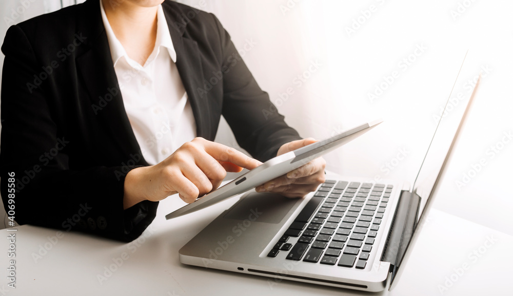 businesswoman hand using smart phone, tablet payments and holding credit card online shopping, omni channel, digital tablet docking keyboard computer at office in sun light