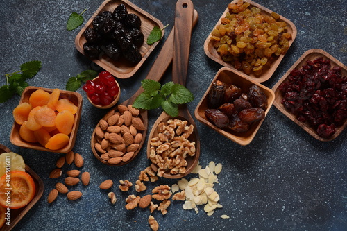 Mix of dried and sun-dried fruits, in a wooden trays . View from above. Symbols of the Jewish holiday of Tu BiShvat © Natalia Hanin