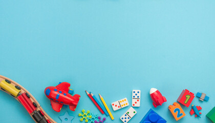 Frame of wooden and plastic kids toys on blue background