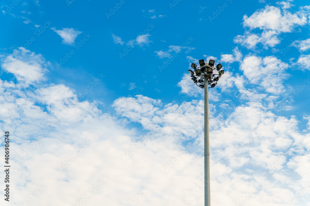 Light pole with blue sky and cloud in city. Spotlight tower.