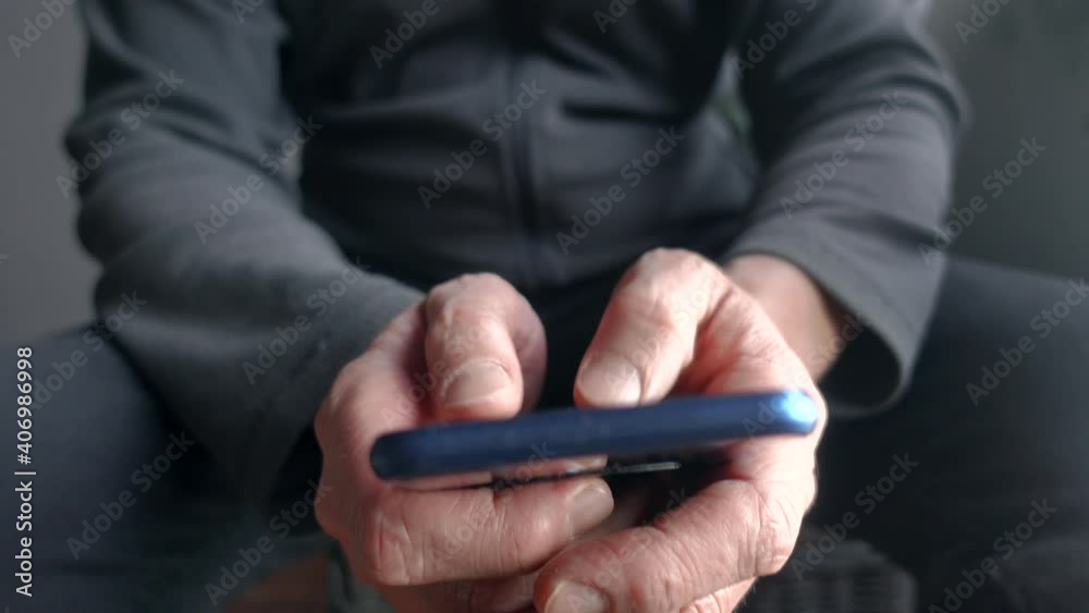 A man texting writing and messaging with thumbs on a smartphone.