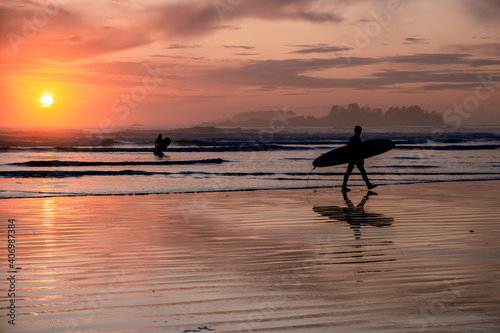 Photos Tofino Vancouver Island Pacific rim coast, surfers with board during sunset at t