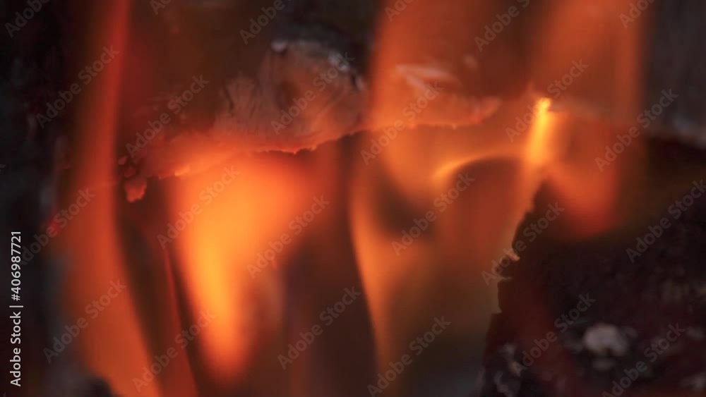 Bonfire burns down, sticks and coals in fire close up, slow motion Bonfire burns down, sticks and coals in fire close up, slow motion