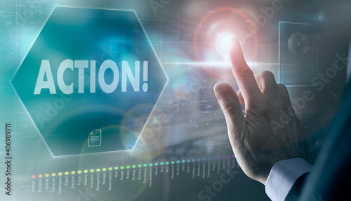 A businessman controlling a futuristic display with a Action business concept on it.