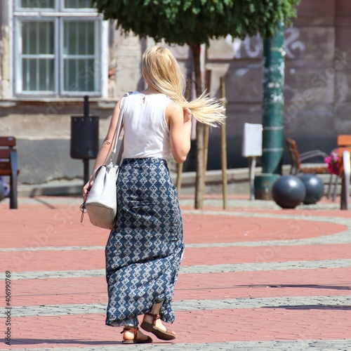 people walking on the street on a sunny day
