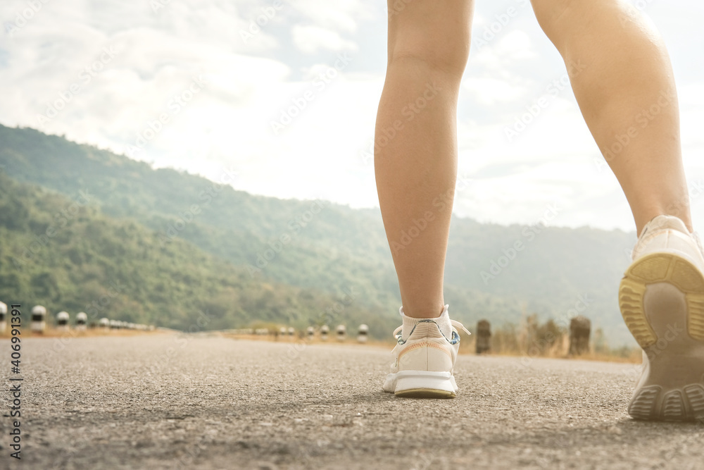 woman legs,running on empty road