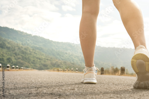 woman legs,running on empty road