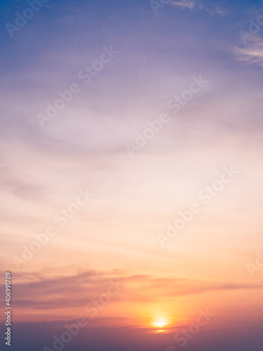 Sunset sky in the evening on twilight with orange and purple sunlight sky nature background,Dusk sky vertical.   © Nature Peaceful 