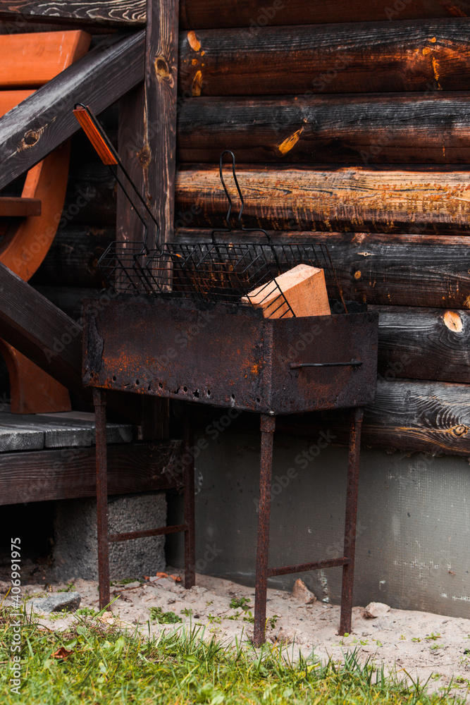 Barbecue rusty metal grill with wood.