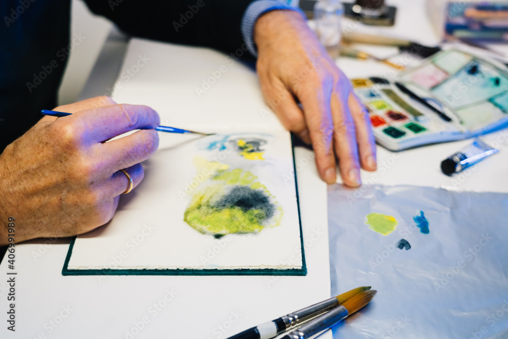 Man painting with airbrushing a work of art Man painting with airbrushing a work of art