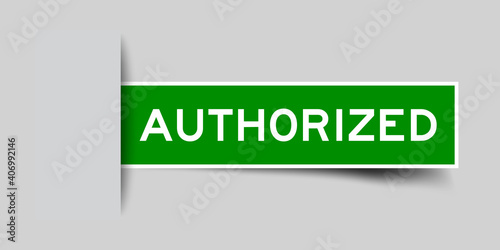 Inserted green color label sticker with word authorized on gray background