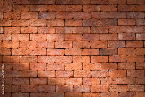 Red brick wall with shining light for background.
