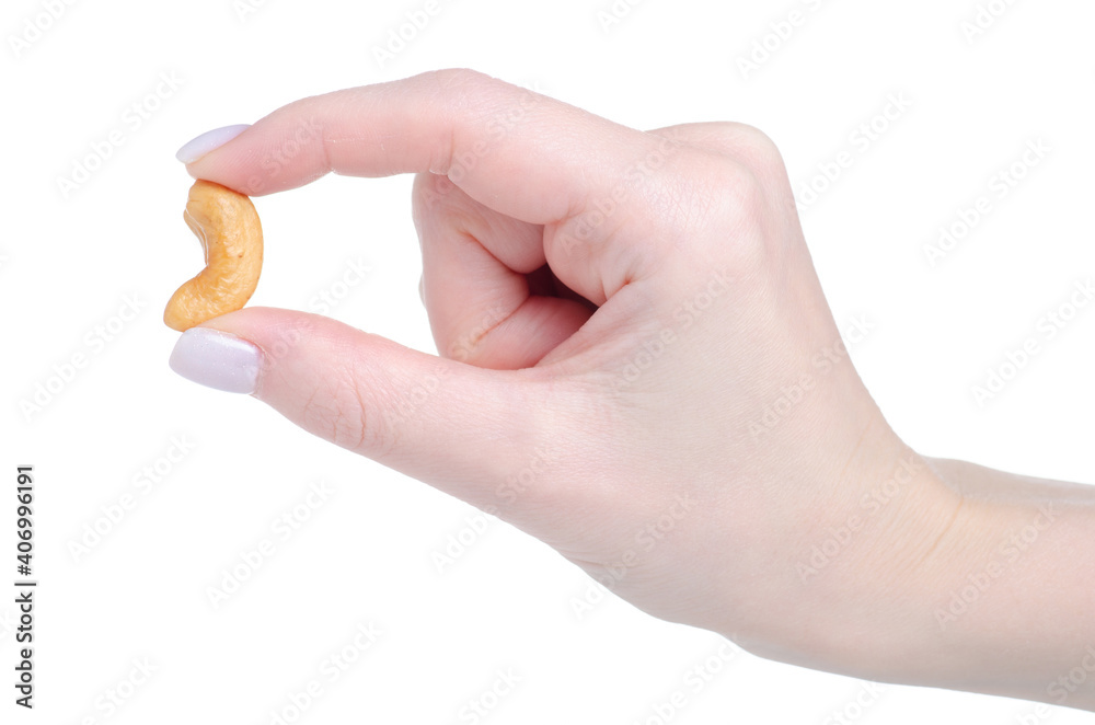 Roasted cashew nuts in hand on white background isolation Roasted cashew nuts in hand on white background isolation