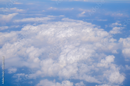 Blue sky background with tiny clouds from airplane