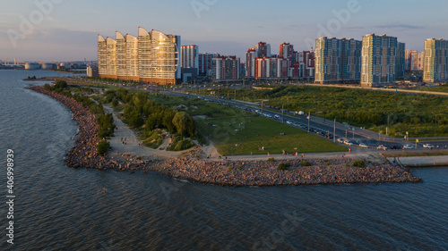 Saint-Petersburg. The beach near the new buildings of the Parusa residential complex. People relax on the beach. photo