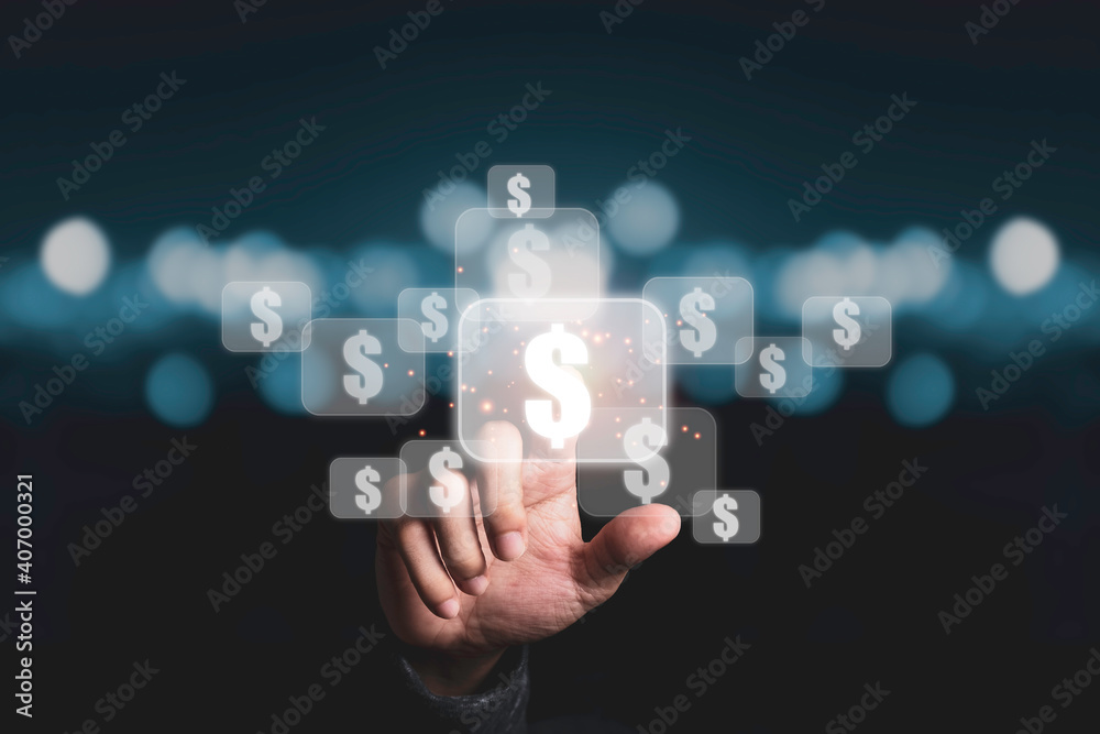 Hand touching to virtual US dollar sign with blue bokeh background, USD is United state of America currency which is the main exchange and popular in the world. Hand touching to virtual US dollar sign with blue bokeh background, USD is United state of America currency which is the main exchange and popular in the world.
