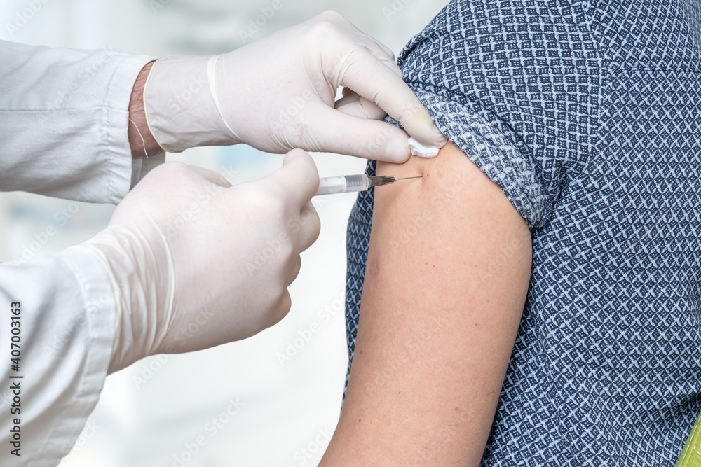 Doctor vaccinating a woman to protect against Covid-19 Doctor vaccinating a woman to protect against Covid-19