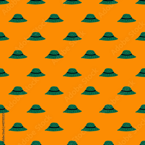 Summer hat seamless pattern with doodle green panama ornament. Bright orange background.