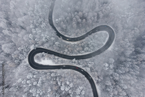 Aerial winter view of the curvy mountain road, in Poiana Brasov © alexionutcoman