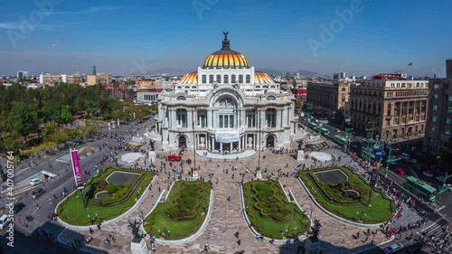 Zoom out time lapse view of people and traffic around the Palace of Fine Arts (Spanish: Palacio de Bellas Artes ) in the Historic Center of Mexico City, Mexico. photo