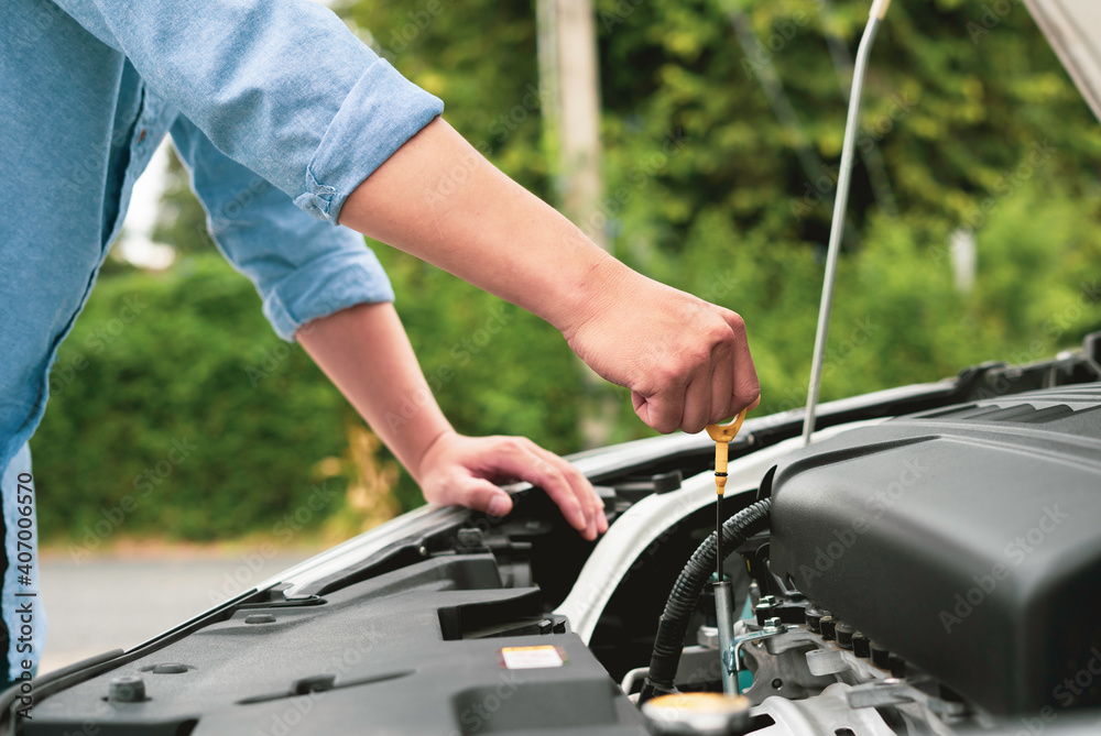 The male mechanic's hand checked the level of engine oil. And engine readiness before departure, concept of engineer and car repair The male mechanic's hand checked the level of engine oil. And engine readiness before departure, concept of engineer and car repair
