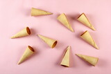 Emty Ice cream cones pattern on pink background. Top view. Several wafer ice cream cones designe