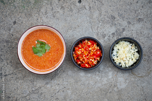 Thai style suki sauce in bowl and topping which are a Chopped chilli, Garlic alley, are arranged on table