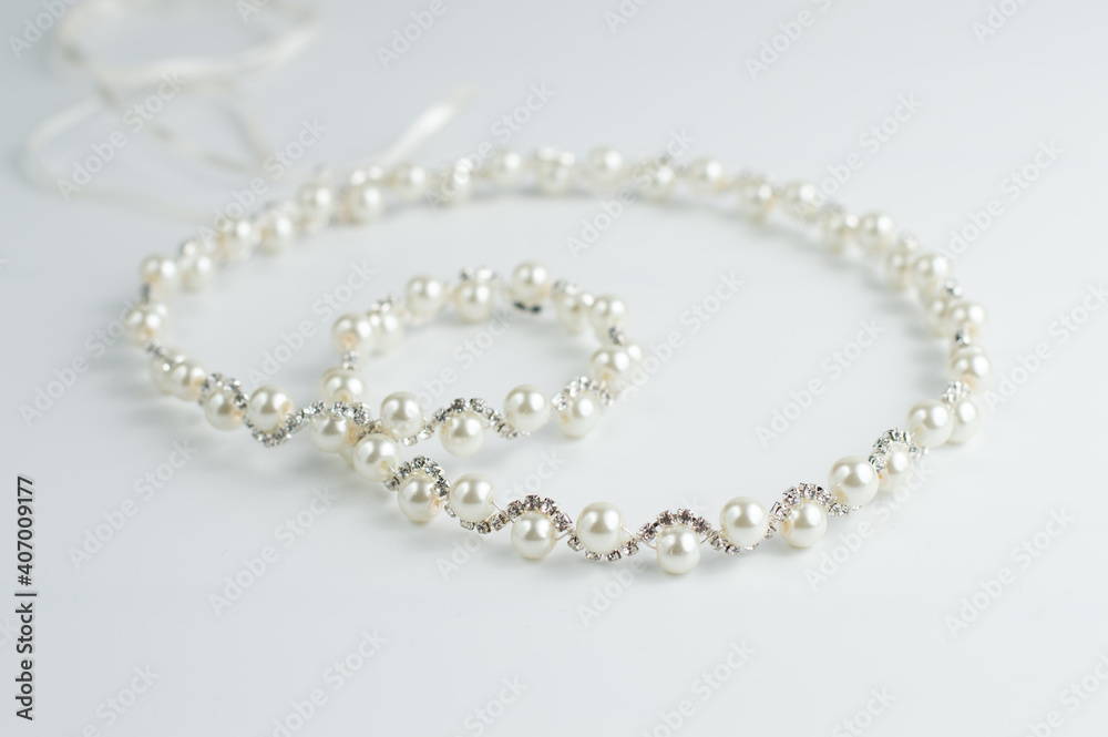 On a white background, decoration from rhinestones and beads. On a white background, decoration from rhinestones and beads.