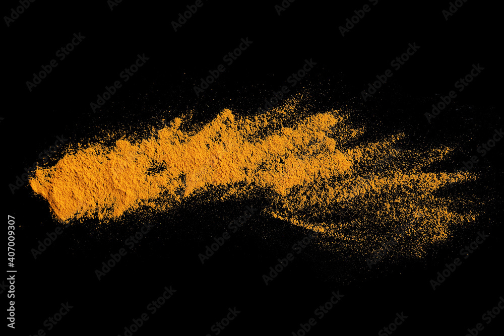 Turmeric Powder Splatter Isolated splashes of turmeric on a black background. Explosion ...