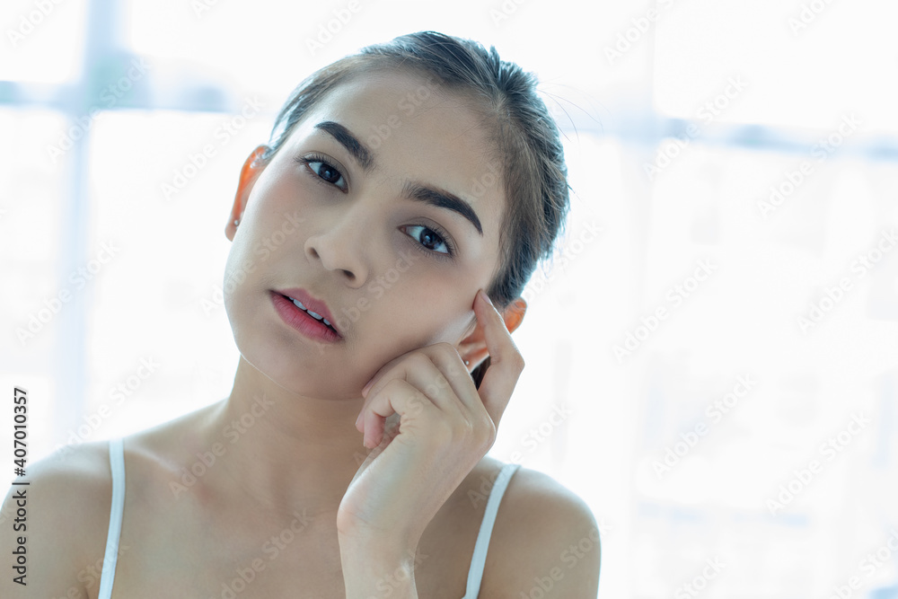 A beautiful woman asian using a skin care product, moisturizer or lotion taking care of her dry complexion. Moisturizing cream in female hands . A beautiful woman asian using a skin care product, moisturizer or lotion taking care of her dry complexion. Moisturizing cream in female hands .